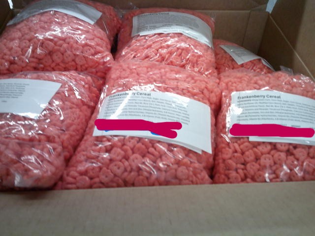 Cardboard box of bags of Franken berry cereal.